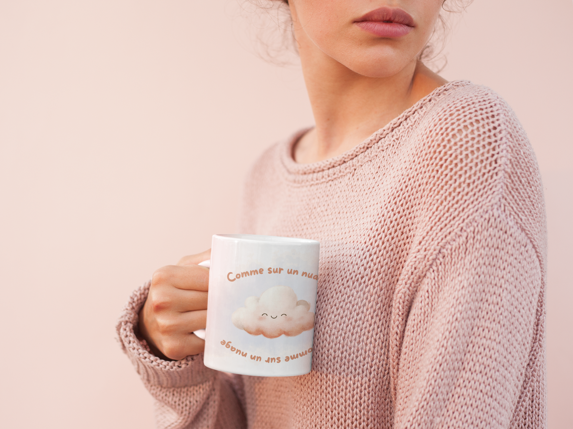 Woman dressed in pink holding a cute white Ceramic mug 