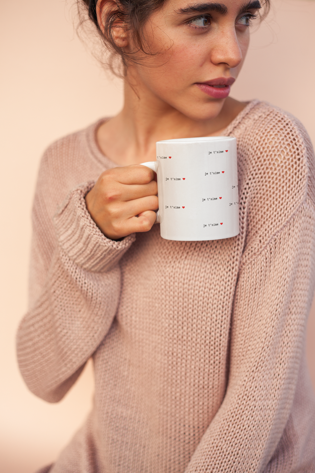 coffee mug mockup held by a woman wearing a cozy sweater